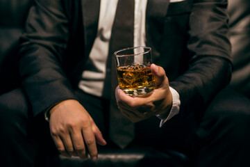 Businessmen in suits drinking whiskey