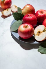 Fresh red apples with green leaves on a light background. Fruits. Top view, copy space.