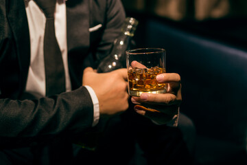 Businessmen in suits drinking whiskey