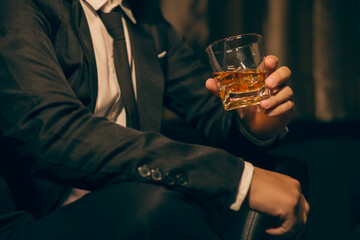 Businessmen in suits drinking whiskey