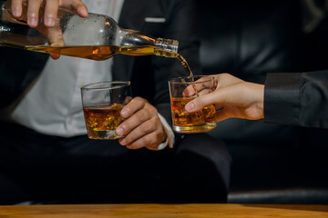 Businessmen in suits drinking whiskey