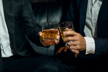 Businessmen in suits drinking whiskey