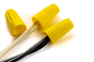 black and white, hot and neutral pieces of non metallic electric wiring connected by a wire nut or...