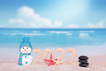 New year 2022 made of twine and snowman on sunny beach