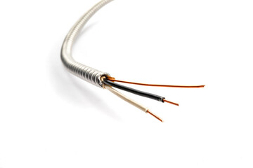 a closeup view of the conductors hot neutral and ground in a piece of armored electrical cable...