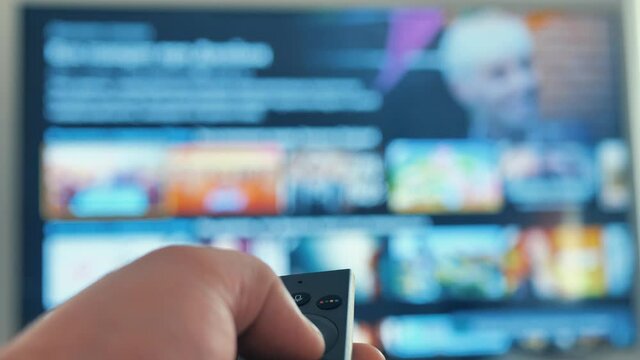 Man hand browsing smart tv apps,zapping channel,leisure lock down home lifestyle