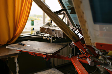 print screening apparatus. serigraph printing production. silk screen textile printery