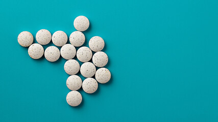 white pills on blue background copy space