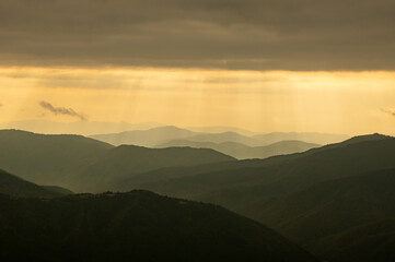 Morning sunlight in spring mountains. Beautiful sun rays on background. Landscape photography