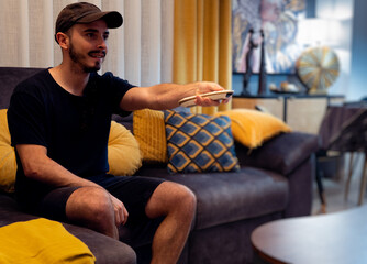 Boy using tv remote in living room