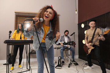 Music band performing in modern recording studio