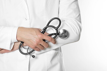 A man in a white coat with a stethoscope. Close up. On a gray background