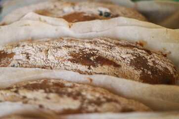 Homemade ciabatta baked on parchment close-up.  Healthy baked goods background