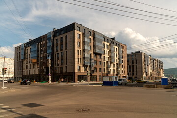 New brick houses under construction on the former territory of the Krasnoyarsk Combine Plant in the city center on a summer day. Russia.