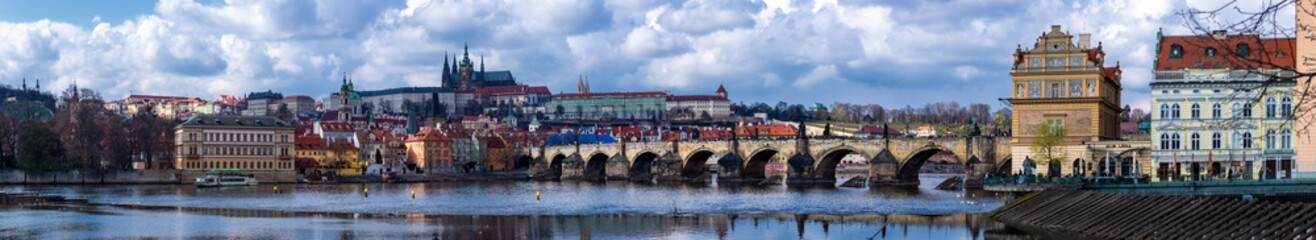 View of the historical part of Prague with the Charles Bridge over the Vltava River and the Gothic cathedrals on the top of the hill in Prague Castle