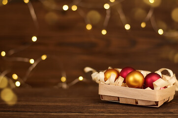 christmas toy in a wicker box on a wooden background