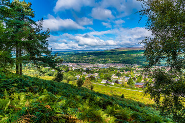 Fototapeta na wymiar A tree framed view from Ilkley moor above the town of Ilkley Yorkshire, UK in summertime