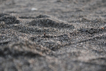 Black sand. Large black sand for the background. Close-up photos, selective focus.