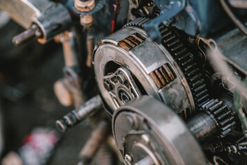 Close-up maintenance of motorcycle engine clutch system.