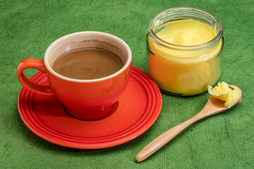 cup of fresh fatty coffee with ghee (clarified butter), MCT oil - ketogenic diet concept