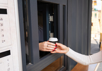 Takeaway coffee in the hands of a girl. Take a break from work and study and go outside.