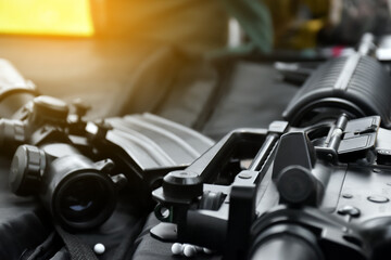 Airsoft or bbgun on black leather background. Selective and soft focus. concept for sport and recreations.