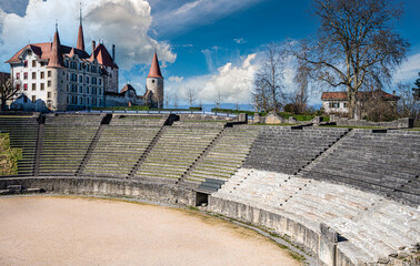 Ancient roman amphitheater and the Avenches castle in the background in the city of Avenches, canton of Vaud, Switzerland - obrazy, fototapety, plakaty