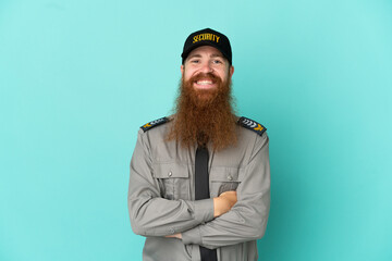 Redhead security man isolated on white background keeping the arms crossed in frontal position