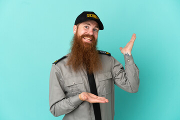 Redhead security man isolated on white background extending hands to the side for inviting to come