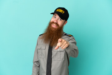 Redhead security man isolated on white background points finger at you with a confident expression