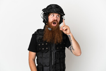 Redhead SWAT isolated on white background thinking an idea pointing the finger up