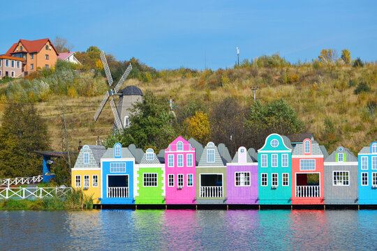 Small Red, green, purple and yellow wooden houses in a coastal fishing village.