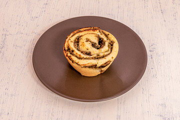 Cinnamon roll stuffed with garlic mushroom stew on brown plate