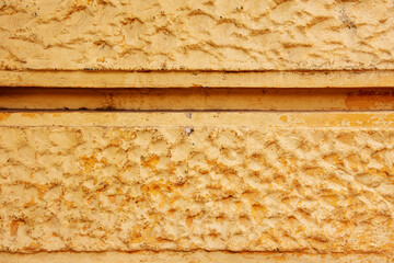 Cement wall of a building filled with decorative bas-reliefs. Vector concrete background texture