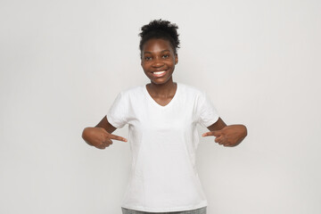 cute african female in white t-shirt showing herself 