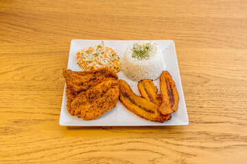 Venezuelan chicken schnitzel with fried plantain, coleslaw and cooked white rice