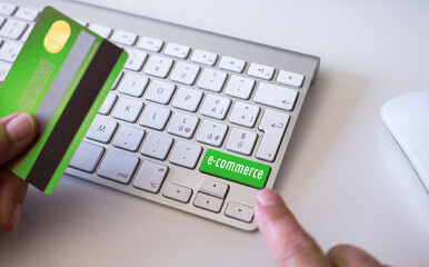 Woman's hands holding credit card using computer for online shopping, e-commerce, spending money, buyer, consumer, technology