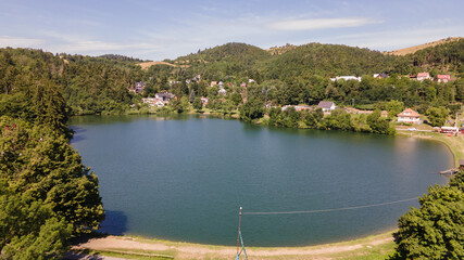 Fototapeta premium Aerial view of Vindsachtske lake in the village of Stiavnicke Bane in Slovakia
