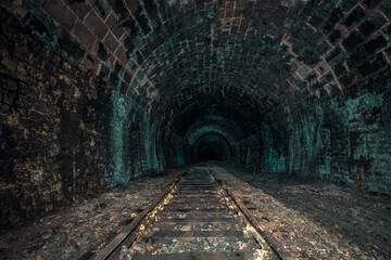 Fototapeta na wymiar An old abandoned railway tunnel decayed for decades a lost place