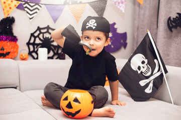 A cute five year old boy stayed at home with a bucket of pumpkin candy in a pirate costume. Ready...