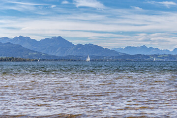 Beautiful landscape scenery with sailing boats in the water and mountains in the background at lake...