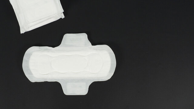 Sanitary napkin with wing is isolated on black background.no people