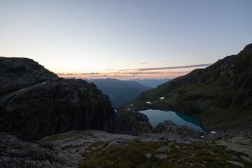 Fototapeta na wymiar Wonderful view over a beautiful alpine lake in Switzerland called Schottensee. Epic sunrise over a perfect blue lake.