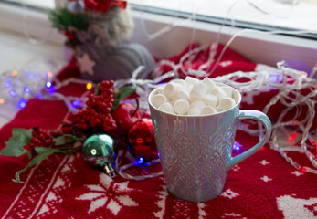 Christmas cozy mood composition on the windowsill, decorative Christmas balls, warm plaid