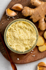 Homemade garlic ginger sauce in a glass bowl close-up. Spicy pasta  with garlic and ginger. Asian and Indian cuisine.
