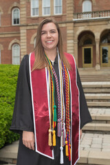 Fototapeta premium Female college graduate with stole and cords