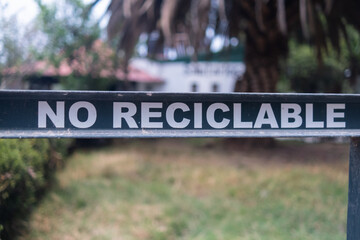 Spanish sign for non-recyclable trash with trees as background