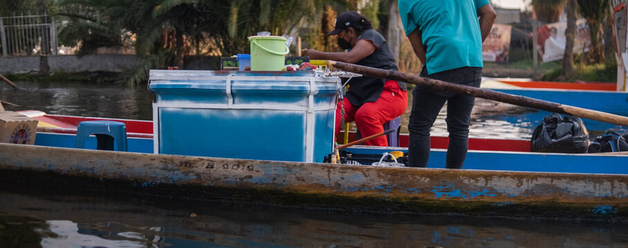 Hispanic Food Vendors In Thin Boat In Xochimilco Lake