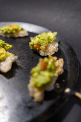 Pork rinds with guacamole on traditional Mexican comal