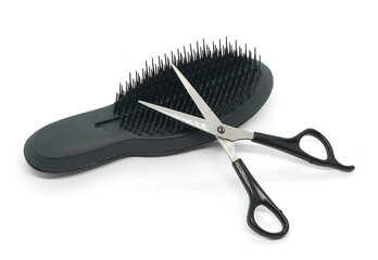 Hairdressing set of black hair brush and scissors. Isolated on white.